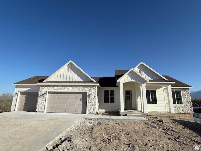 1336 W 800 S Unit 22, Spanish Fork, UT 84660 - view of front of house with board and batten siding, a porch, an attached garage, and driveway
