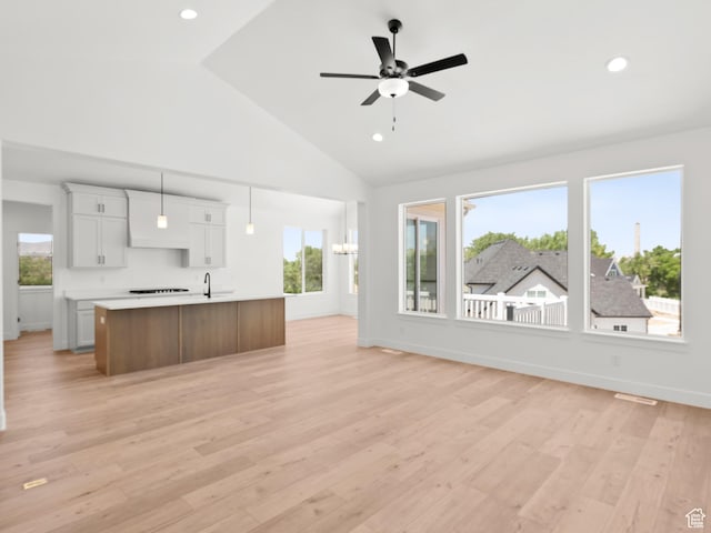 1336 W 800 S Unit 22, Spanish Fork, UT 84660 - kitchen with light countertops, open floor plan, an island with sink, plenty of natural light, and high vaulted ceiling