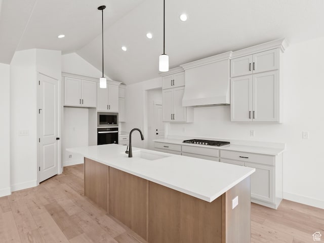 1336 W 800 S Unit 22, Spanish Fork, UT 84660 - kitchen featuring oven, stainless steel microwave, custom exhaust hood, vaulted ceiling, and light wood finished floors