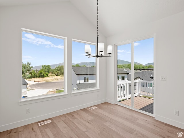1336 W 800 S Unit 22, Spanish Fork, UT 84660 - unfurnished dining area with a mountain view, a chandelier, vaulted ceiling, and wood finished floors
