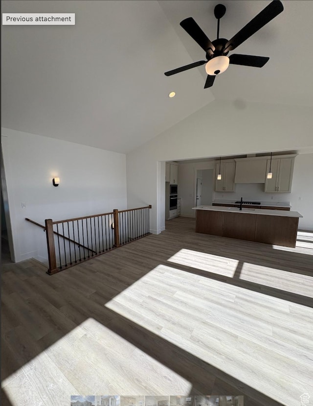 285 N 990 E Unit 13, Salem, UT 84653 - unfurnished living room featuring wood finished floors, ceiling fan, high vaulted ceiling, baseboards, and recessed lighting