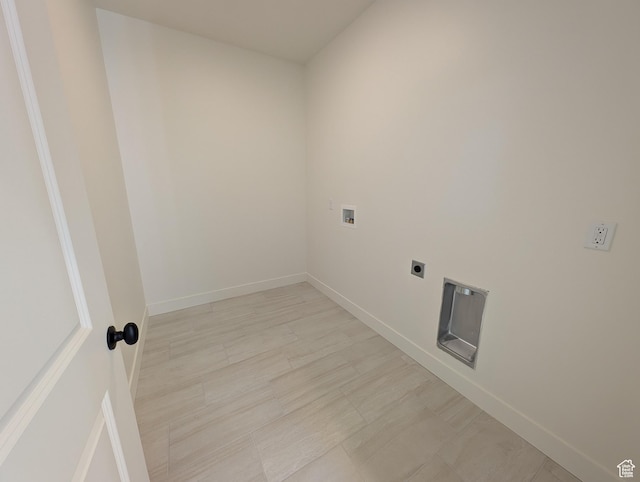 clothes washing area featuring laundry area, hookup for an electric dryer, baseboards, and hookup for a washing machine