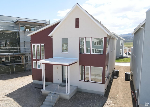 view of front of home featuring central AC unit and stucco siding