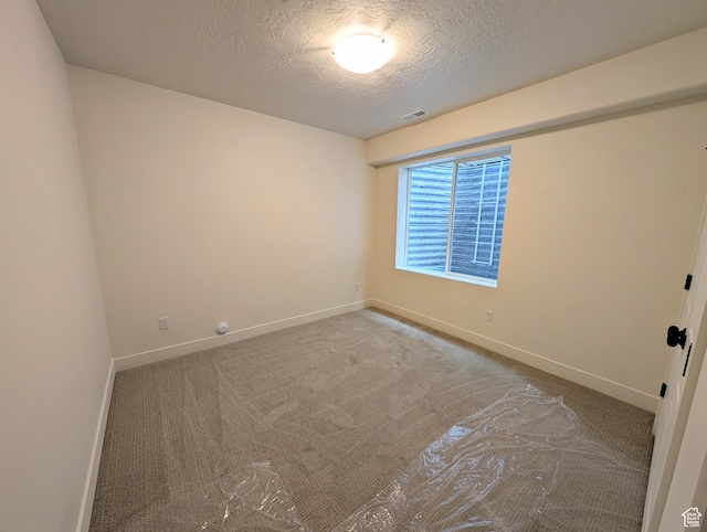 6967 W Lake Ave S Unit 324, South Jordan, UT 84009 - spare room featuring a textured ceiling, baseboards, and carpet flooring