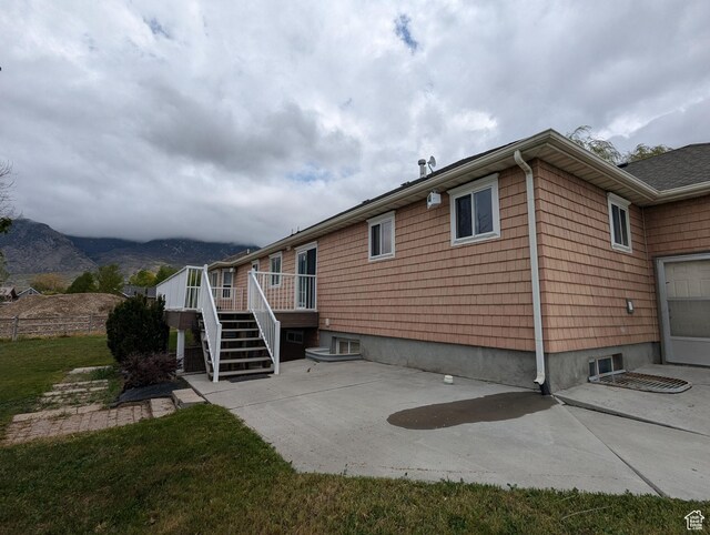 565 E Platt Ln Unit 1, Mona, UT 84645 - view of home's exterior featuring a patio, a deck with mountain view, and stairs