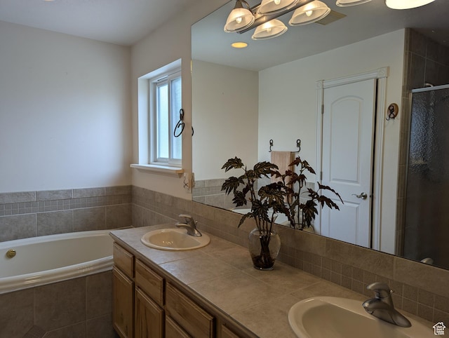 565 E Platt Ln Unit 1, Mona, UT 84645 - full bath featuring a bath, decorative backsplash, double vanity, and a sink