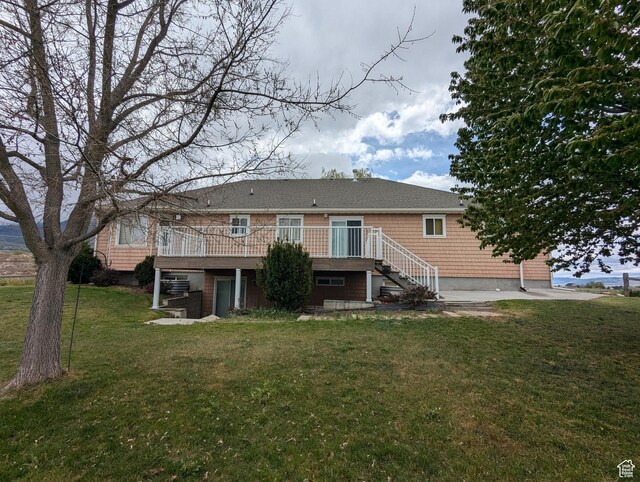 565 E Platt Ln Unit 1, Mona, UT 84645 - back of house featuring stairway, a deck, and a lawn