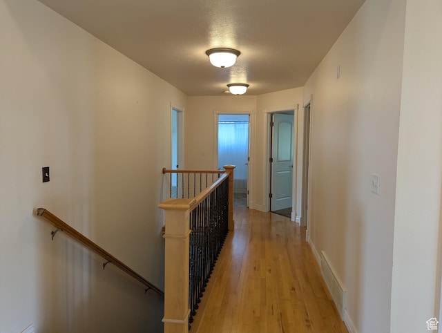 565 E Platt Ln Unit 1, Mona, UT 84645 - corridor with light wood finished floors, visible vents, an upstairs landing, and baseboards