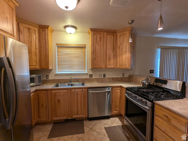565 E Platt Ln Unit 1, Mona, UT 84645 - kitchen featuring light tile patterned floors, hanging light fixtures, visible vents, a sink, and stainless steel appliances