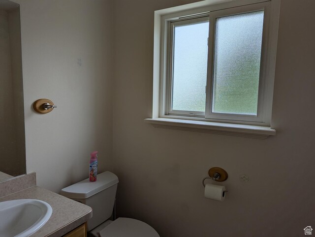 565 E Platt Ln Unit 1, Mona, UT 84645 - half bathroom with vanity, toilet, and a healthy amount of sunlight