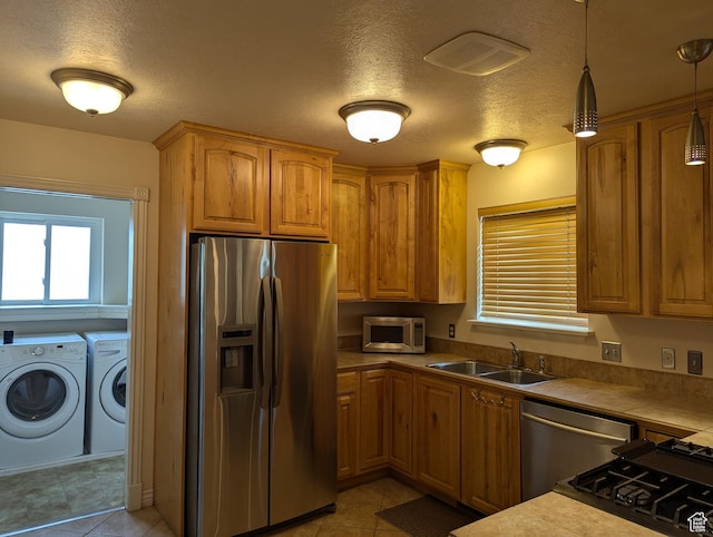 565 E Platt Ln Unit 1, Mona, UT 84645 - kitchen featuring a sink, stainless steel appliances, a textured ceiling, and independent washer and dryer