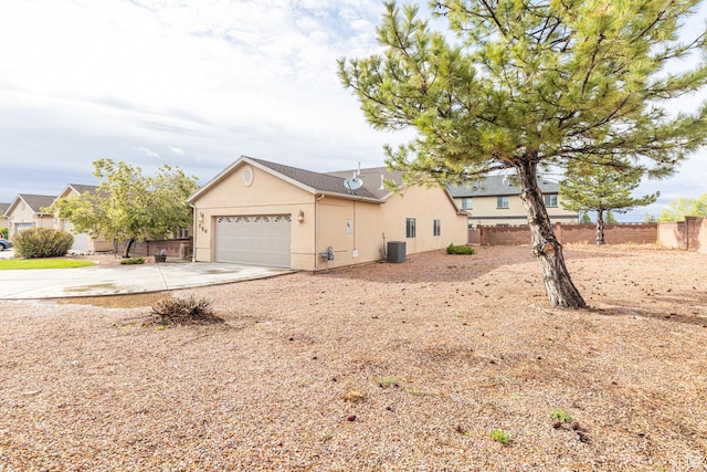 396 W 1500 N, Enoch, UT 84721 - view of front of home with driveway, fence, cooling unit, a garage, and stucco siding