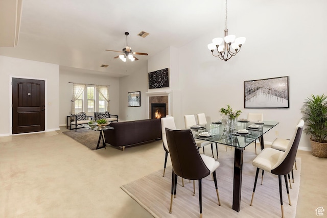 396 W 1500 N, Enoch, UT 84721 - dining area with baseboards, visible vents, ceiling fan with notable chandelier, vaulted ceiling, and a tile fireplace