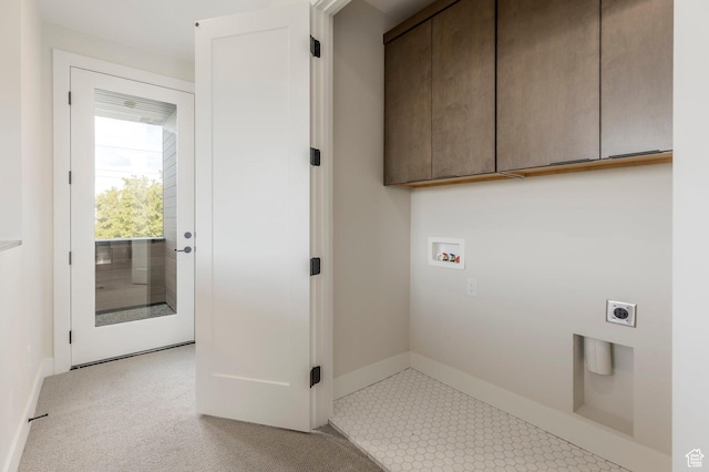 clothes washing area with cabinet space, baseboards, hookup for an electric dryer, and hookup for a washing machine