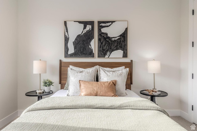bedroom featuring carpet and baseboards