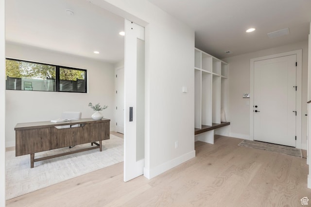 interior space featuring wood finished floors, baseboards, and recessed lighting