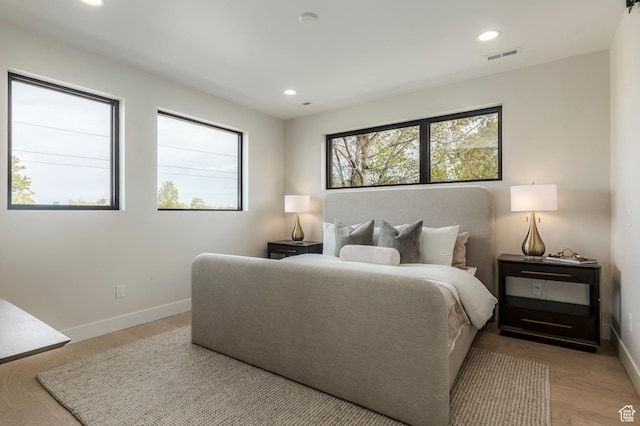 bedroom with baseboards, recessed lighting, and visible vents