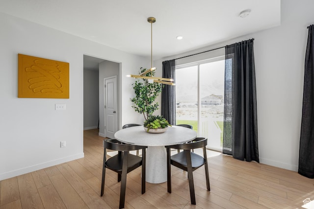 dining room featuring baseboards, recessed lighting, and light wood-type flooring