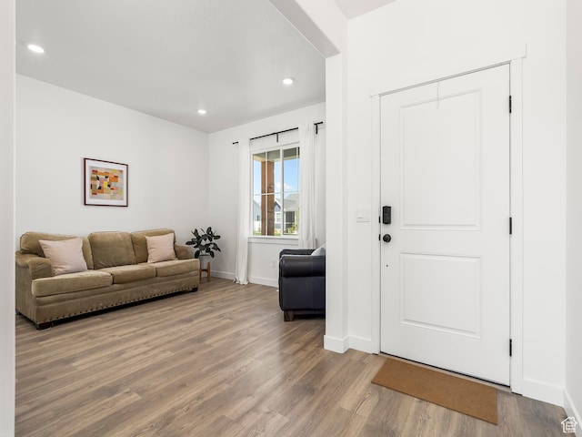 interior space with baseboards, recessed lighting, and wood finished floors