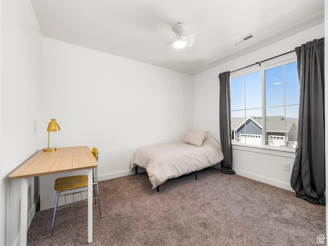 carpeted bedroom featuring visible vents, baseboards, and ceiling fan
