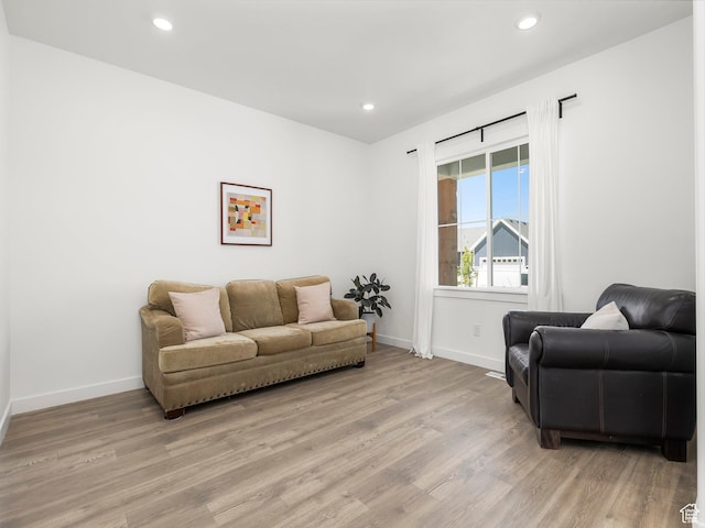 living area with light wood-style floors and baseboards