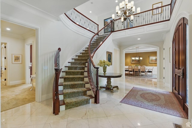 2428 E Field Rose Dr, Holladay, UT 84121 - entrance foyer with stairs, an inviting chandelier, crown molding, arched walkways, and a high ceiling