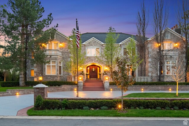 2428 E Field Rose Dr, Holladay, UT 84121 - view of front facade with stone siding and a balcony