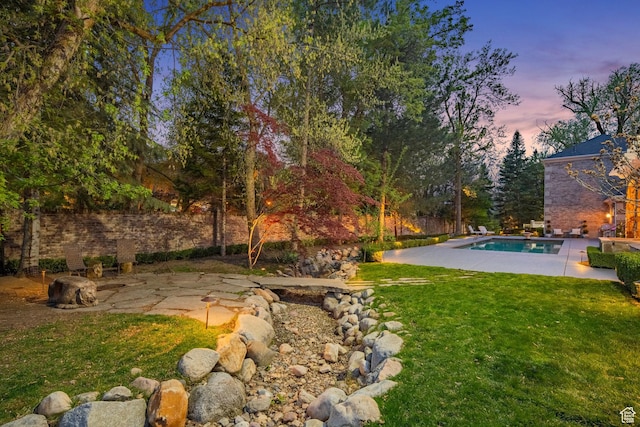 2428 E Field Rose Dr, Holladay, UT 84121 - yard at dusk featuring a patio area and an outdoor pool
