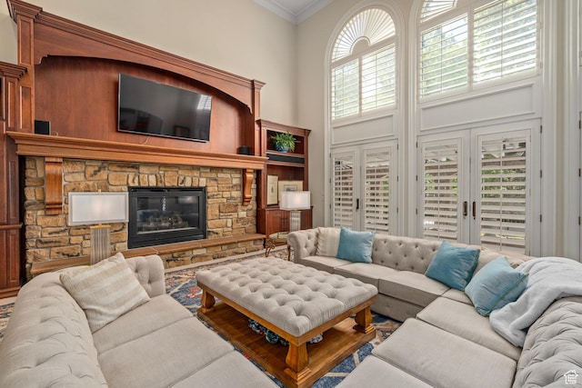2428 E Field Rose Dr, Holladay, UT 84121 - living area with a stone fireplace, a high ceiling, and crown molding