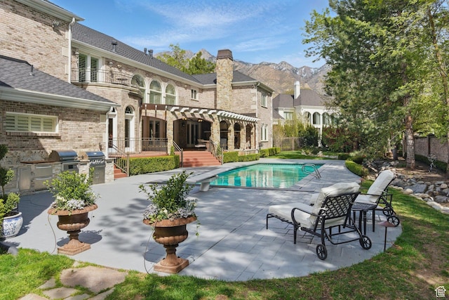 2428 E Field Rose Dr, Holladay, UT 84121 - outdoor pool featuring a patio area, area for grilling, a mountain view, and a diving board