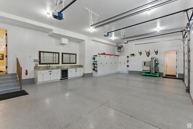 2428 E Field Rose Dr, Holladay, UT 84121 - garage with wine cooler, baseboards, a sink, and a garage door opener