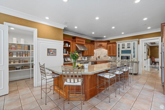 2428 E Field Rose Dr, Holladay, UT 84121 - kitchen with a breakfast bar, ornamental molding, stainless steel appliances, and wall chimney exhaust hood