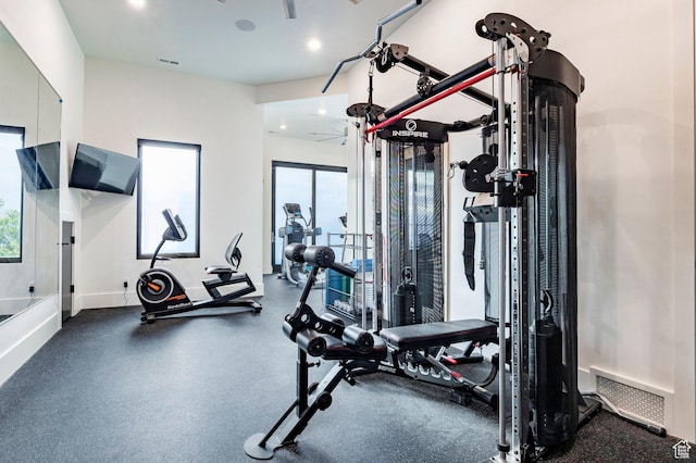 workout area featuring recessed lighting and baseboards