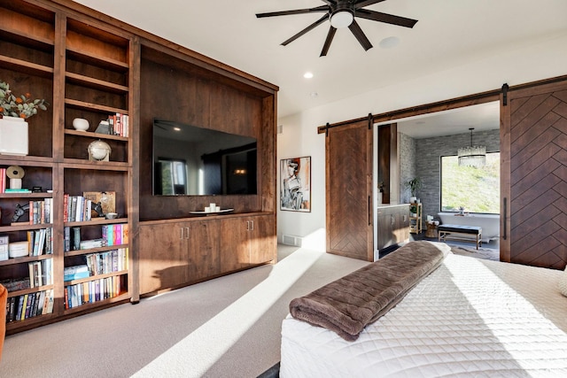 bedroom featuring a barn door and carpet