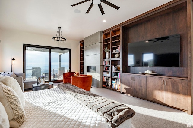 carpeted bedroom with access to exterior, a tile fireplace, recessed lighting, and a ceiling fan