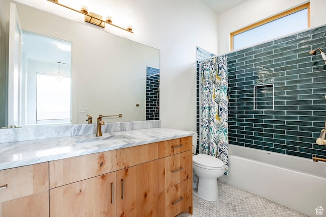 bathroom with tile patterned flooring, toilet, vanity, and shower / bath combo with shower curtain
