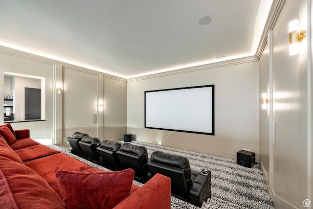 carpeted home theater featuring baseboards and crown molding