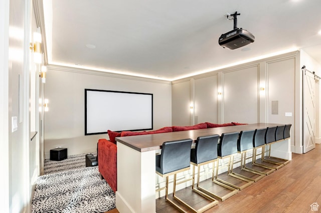 cinema room with light wood-style floors