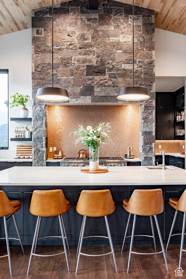 indoor wet bar with vaulted ceiling, wood ceiling, dark wood-type flooring, decorative light fixtures, and tasteful backsplash