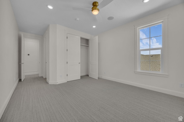 unfurnished bedroom with light carpet, baseboards, and recessed lighting