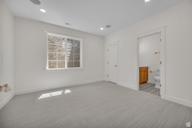 unfurnished bedroom with baseboards, visible vents, and carpet