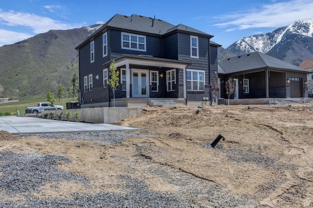 view of front facade with french doors and a mountain view