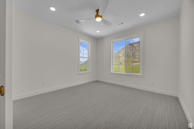 spare room with a ceiling fan, recessed lighting, baseboards, visible vents, and carpet floors