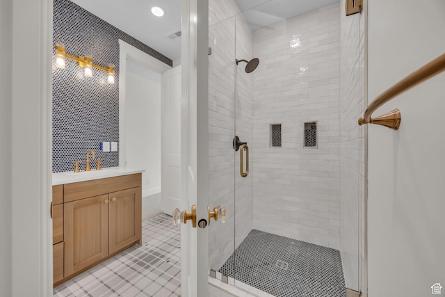 full bathroom with a stall shower, tile patterned flooring, vanity, and visible vents