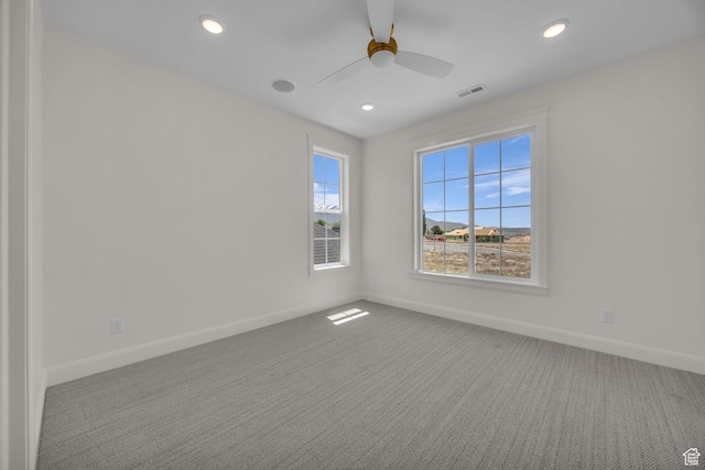 carpeted spare room featuring visible vents, baseboards, a ceiling fan, and recessed lighting
