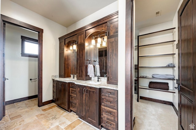 787 N Red Ledges Blvd, Heber City, UT 84032 - bathroom with baseboards, visible vents, double vanity, and a sink