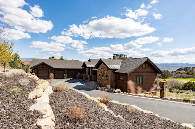 787 N Red Ledges Blvd, Heber City, UT 84032 - view of front of home featuring a standing seam roof, metal roof, an attached garage, concrete driveway, and stone siding
