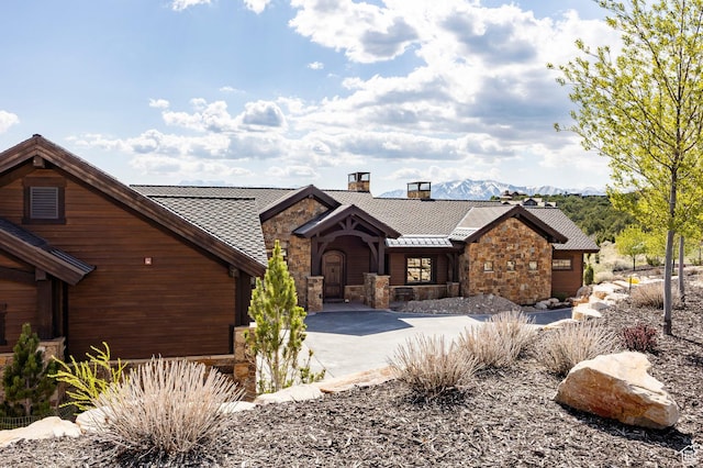 787 N Red Ledges Blvd, Heber City, UT 84032 - rustic home featuring a chimney, driveway, a standing seam roof, a mountain view, and stone siding
