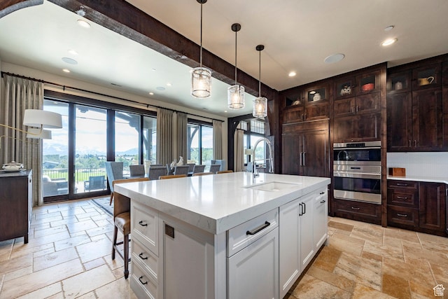 787 N Red Ledges Blvd, Heber City, UT 84032 - kitchen with a sink, stainless steel double oven, white cabinetry, and stone tile flooring