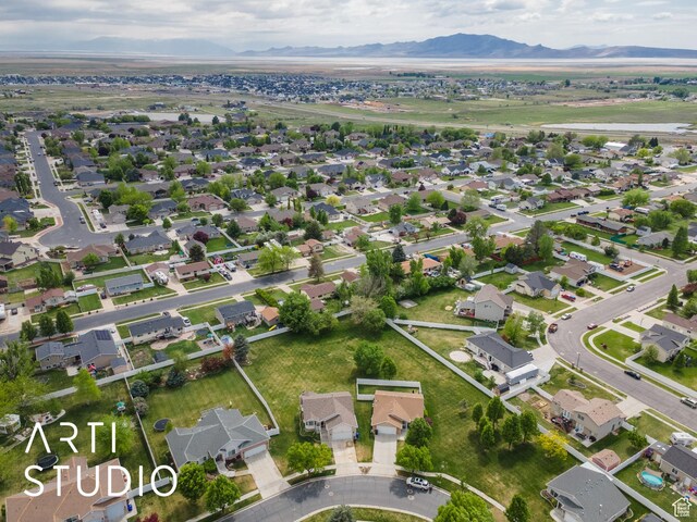birds eye view of property with a mountain view and a residential view